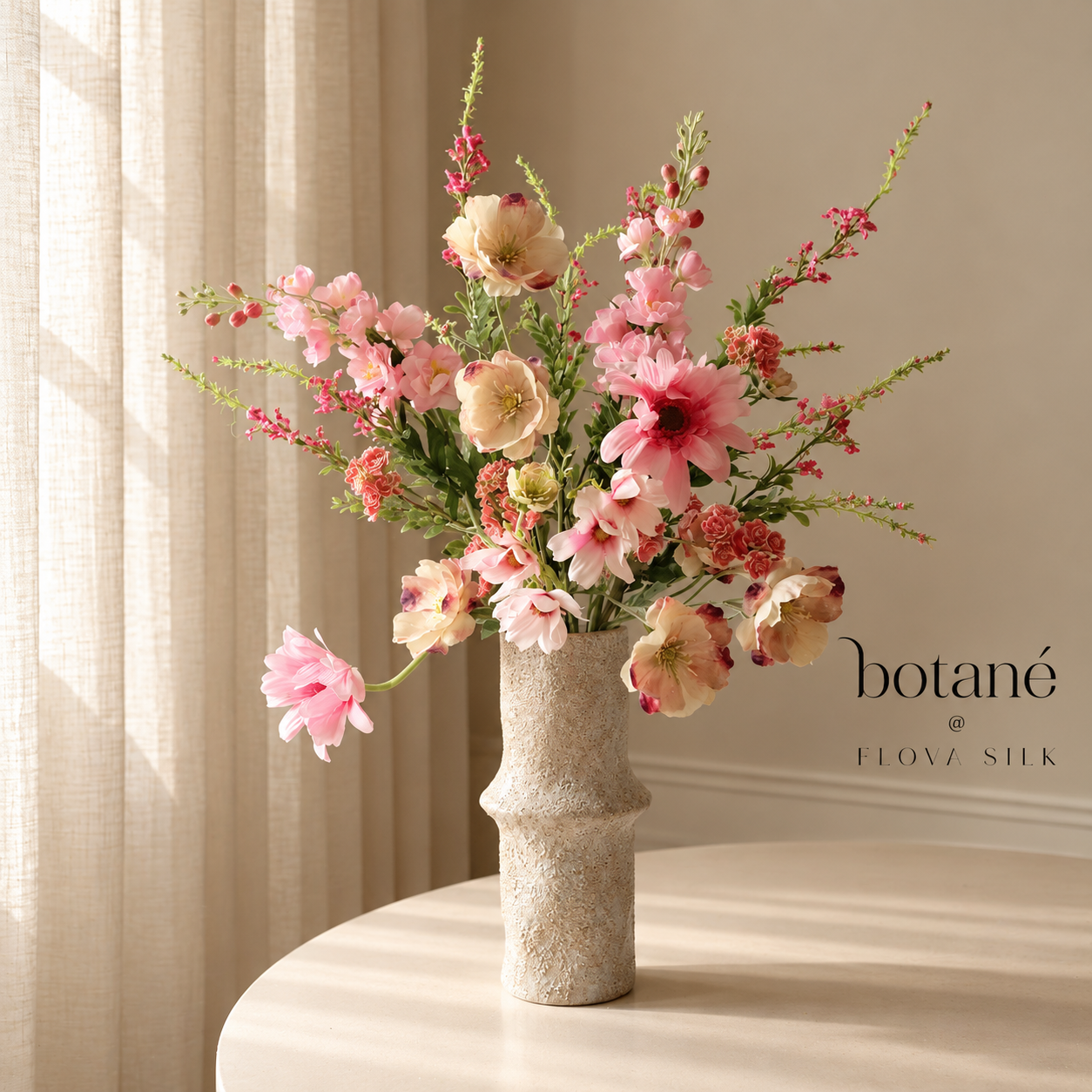 Spring Ballet luxury artificial flower bouquet by Botané with soft pink peonies, tulips and green foliage in a beige ceramic vase.