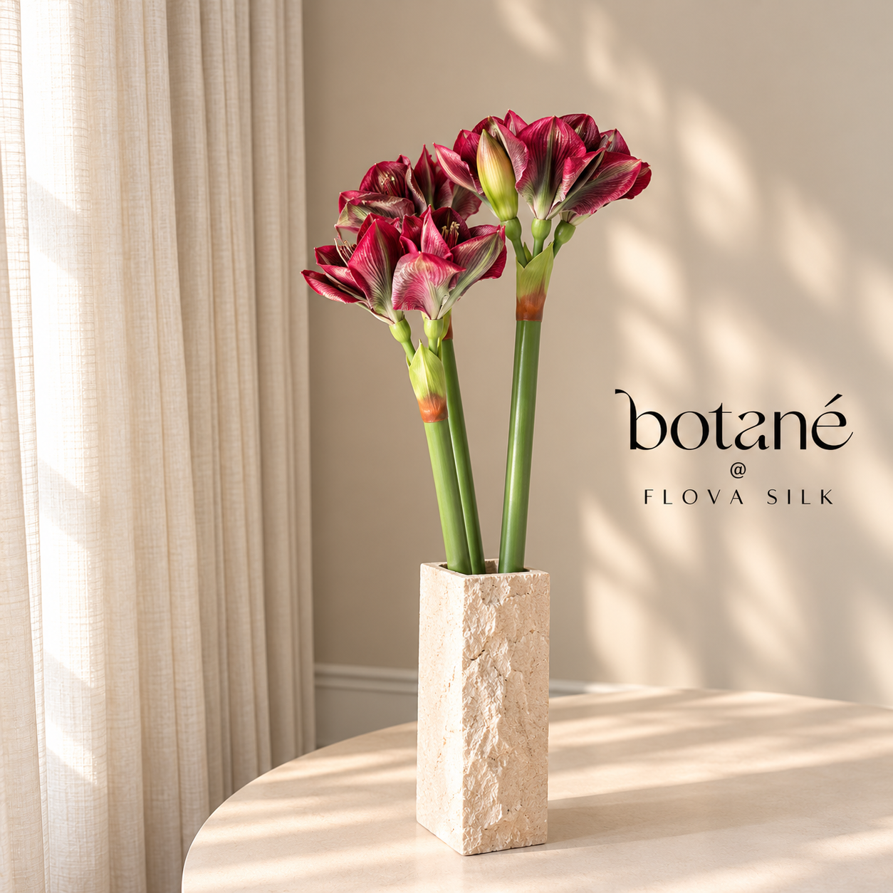Burgundy Amaryllis artificial flower bouquet by Botané at FLOVA SILK, featuring three burgundy and pink striped amaryllis stems in an elegant off-white vase.