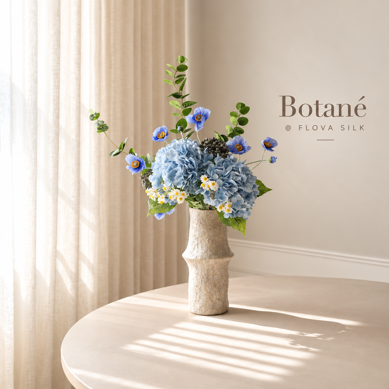 Barbie Blue Bliss luxury artificial flower arrangement by Botané at FLOVA SILK with pale blue hydrangeas, blue poppies, delicate daisies and eucalyptus.